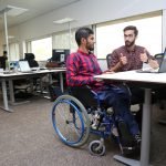 Picture of Two Disabled Persons Working in their Office